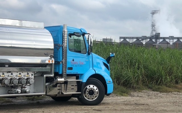 Siarc Inc. Oil & Fuel truck beside a Louisiana sugarcane field